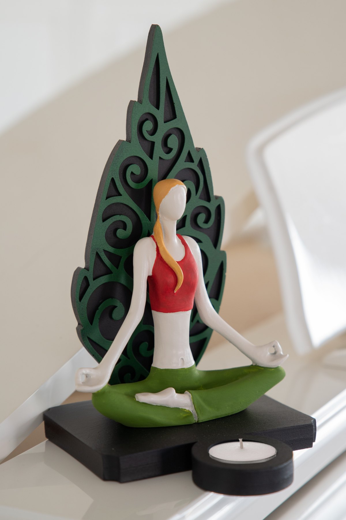 Woman figure doing yoga in green leaf color